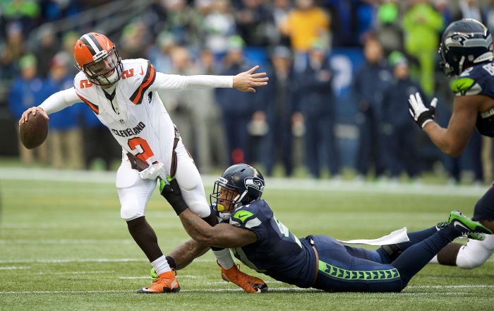 Cleveland Browns quarterback Johnny Manziel (2) get away a pass as he is tackled Seattle Seahawks linebacker Bruce Irvin (51) during a game at CenturyLink Field.
